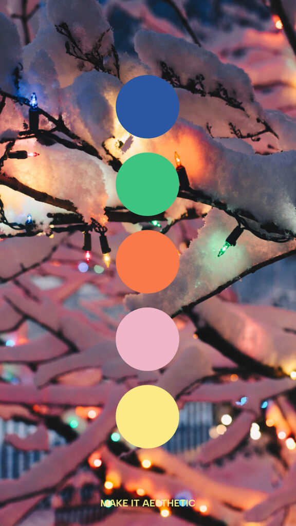 Detail of Garland of colorful lights on a snowy tree. Winter Christmas Color Palette. Blue, green, red, pink, and yellow tones.