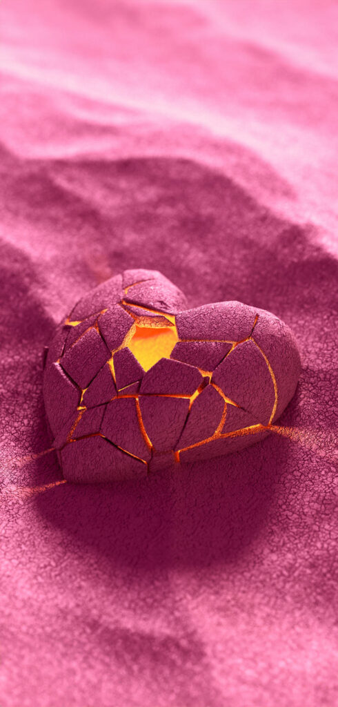 A broken heart-shaped object with golden cracks, lying on a textured pink surface. Free Valentines Aesthetic Wallpapers.

