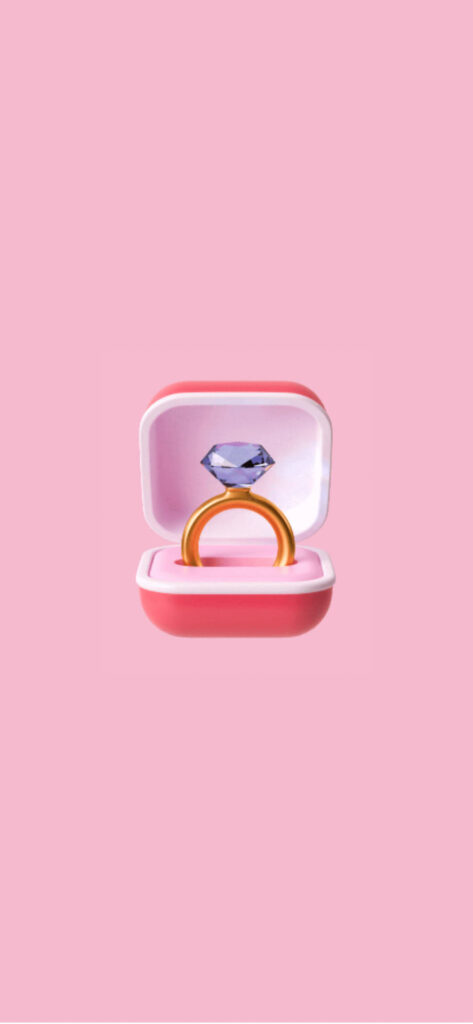 A digital illustration of a diamond ring inside an open pink ring box against a soft pink background. Free Valentines Aesthetic Wallpapers