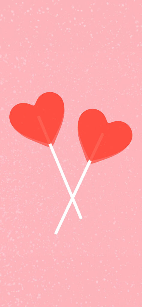 Two red heart-shaped lollipops crossed over each other against a textured pink background. Free Valentines Aesthetic Wallpapers