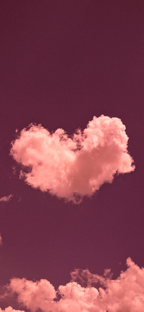 A heart-shaped cloud stands out against a deep purple sky, surrounded by smaller clouds, evoking a sense of love and serenity
